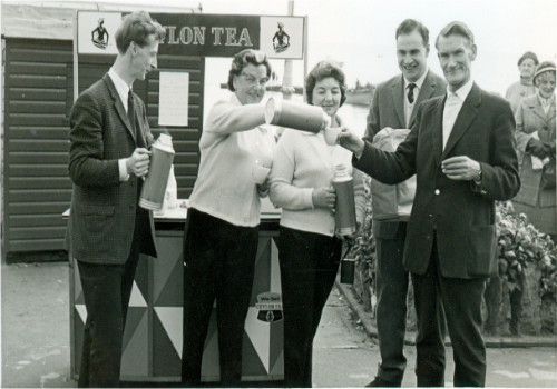 Drinking tea at a sponsored event organised by his wife Peggy.
